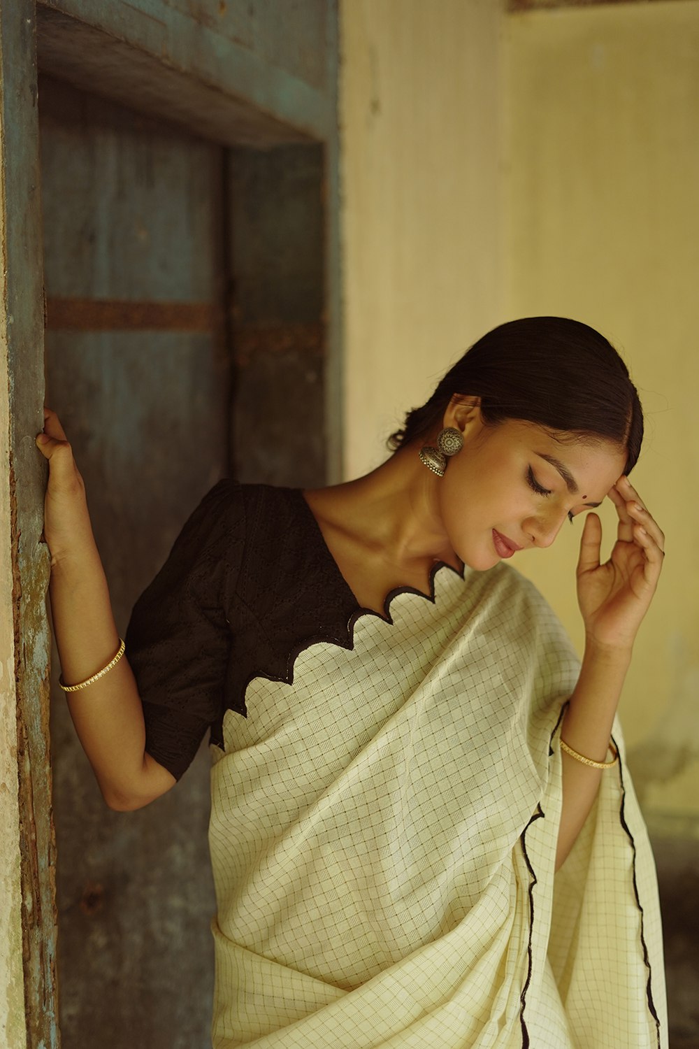 Stylish bengali girl wearing glasses and saree, looking at a rose on Craiyon