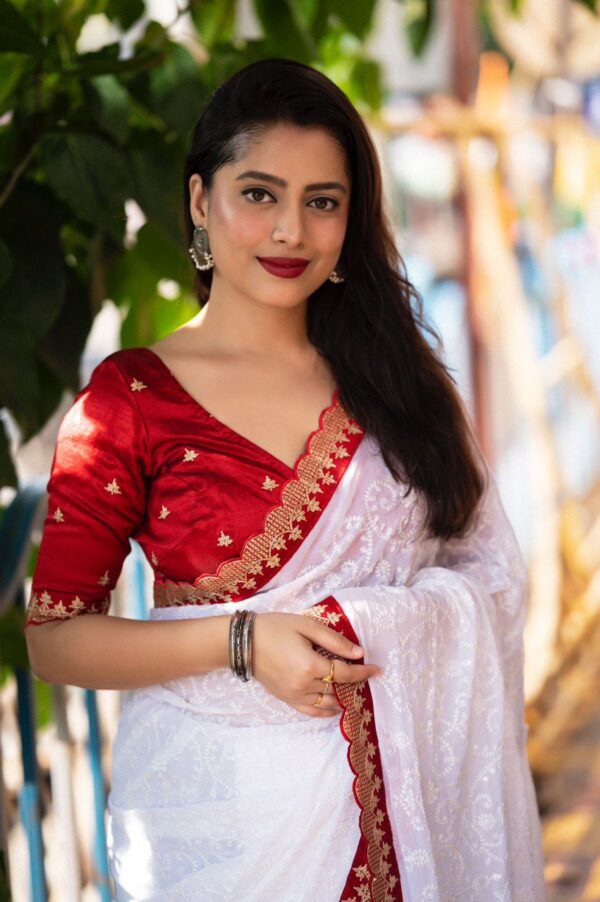 white saree with heavy embroidery work in saree and blouse