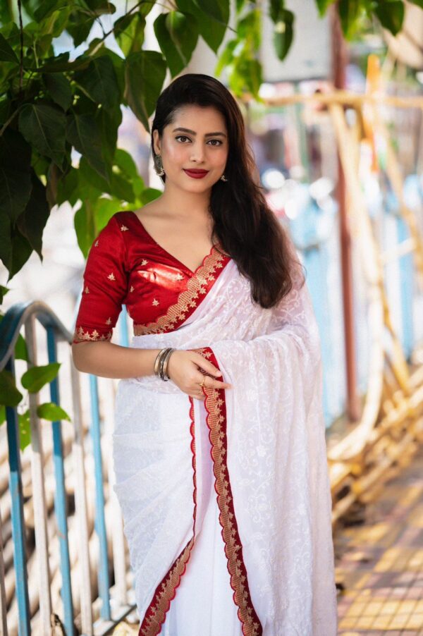 white saree with heavy embroidery work in saree and blouse