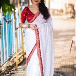 white saree with heavy embroidery work in saree and blouse
